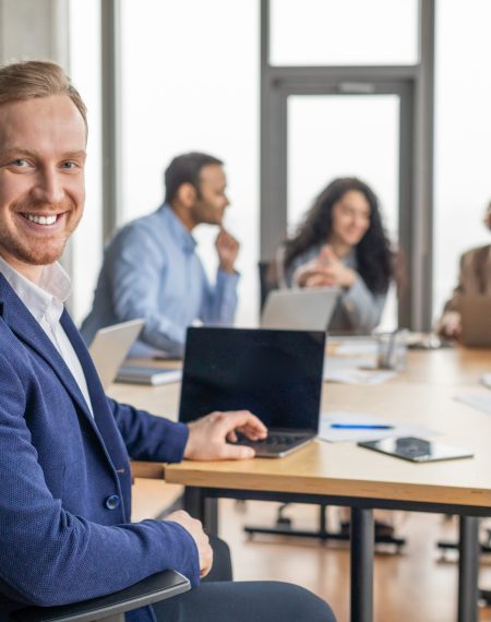 smiling-businessman-sitting-in-meeting-room-with-l-2025-03-18-17-55-10-utc (1)